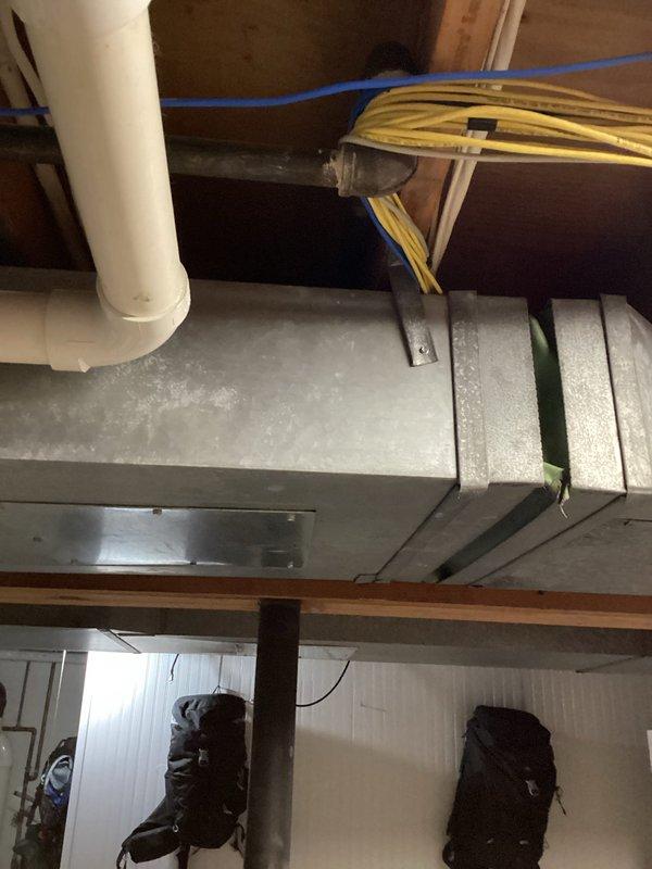 Conducted comprehensive water heater estimate in residential basement utility space. Assessed existing plumbing infrastructure including copper supply lines with age-appropriate patina, PVC drainage systems, and current water heater installation location. Evaluated mechanical room conditions, ductwork clearances, and available space for potential tank or tankless water heater replacement, documenting existing pipe configurations and support systems to provide accurate replacement recommendations.