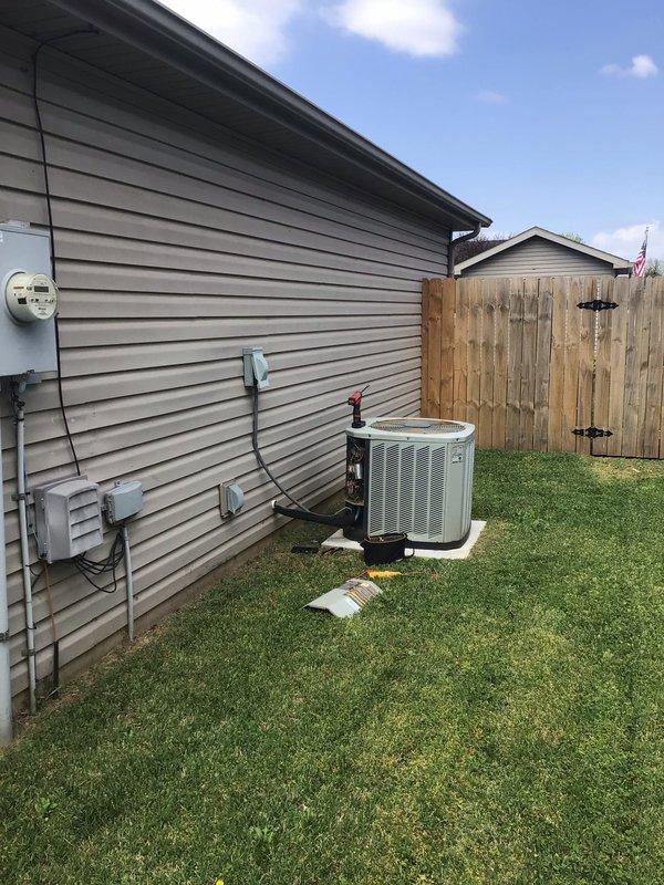 Responded to a no-cooling complaint on a 16-year-old residential air conditioning system. Upon arrival, performed visual inspection of outdoor condensing unit and removed access panel to assess internal components. Found capacitor exhibiting severe deterioration with corroded terminal connections, degraded wiring, and accumulated debris throughout the electrical compartment. Interior housing showed extensive dirt buildup, biological growth, and corrosion on multiple metal surfaces, indicating prolonged lack of maintenance and exposure to elements. Documented unit condition with photographs showing compromised electrical connections, particularly at capacitor terminals where orange wire displayed significant deterioration. System age and component condition suggest end-of-service-life status requiring comprehensive evaluation for repair versus replacement options.