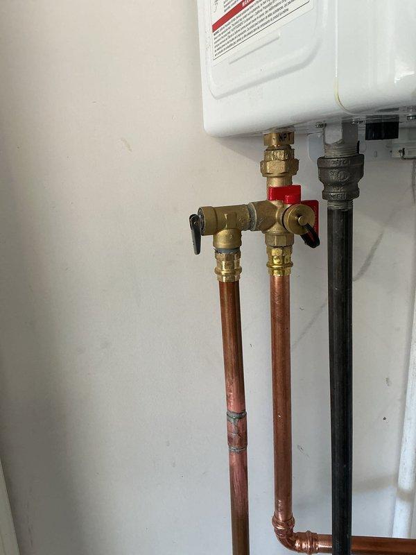 Completed follow-up installation of whole-home humidifier system on existing HVAC air handler unit. Connected humidifier water supply line using copper piping with brass compression fittings and shut-off valve for maintenance access. Verified proper integration with forced air system and tested unit operation to ensure adequate humidity distribution throughout the home.