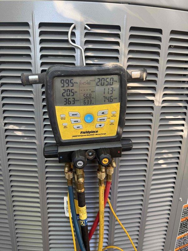 # HVAC Complete System Installation

Successfully completed installation of a 2-ton, 18 SEER high-efficiency split system for the upstairs zone. The system features a 99% AFUE upflow gas furnace positioned in a narrow utility closet with white brick walls. Installation included proper placement of the furnace unit with manufacturer specifications verified, white PVC condensate drain and vent piping routed vertically from the unit, and silver flexible supply ductwork configured to fit the confined space. Black flexible return ducting was connected to the upper portion of the furnace to complete the air distribution system.

Upon completion of the mechanical installation, performed comprehensive system startup and diagnostic testing using digital manifold gauges. Verified refrigerant charge, operating pressures, and temperature differentials across the evaporator coil to ensure optimal system performance. All readings confirmed proper system operation within manufacturer specifications. 