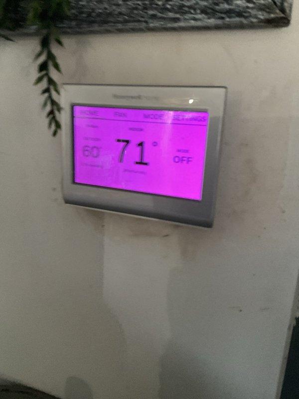 Completed first-year comprehensive maintenance inspection on Bryant residential split system. Verified thermostat operation showing 71°F with system in off mode, confirmed proper display functionality and user interface responsiveness. Performed exterior condenser unit inspection, noting clean coil fins, secure refrigerant line connections, and proper unit placement on concrete pad with adequate clearance for airflow.