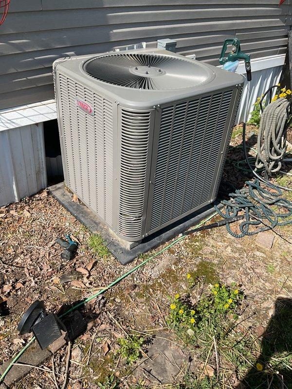 Completed first-year comprehensive maintenance inspection on Bryant residential split system. Verified thermostat operation showing 71°F with system in off mode, confirmed proper display functionality and user interface responsiveness. Performed exterior condenser unit inspection, noting clean coil fins, secure refrigerant line connections, and proper unit placement on concrete pad with adequate clearance for airflow.