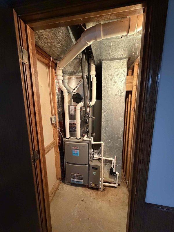 Completed full HVAC system installation including a 2.5-ton, 15.5 SEER Bryant air conditioning unit positioned on concrete pad with proper refrigerant line routing, and a 96% efficiency gas furnace installed in interior utility closet with new ductwork connections and PVC venting. All equipment tested and operational, system financed through third-party provider.