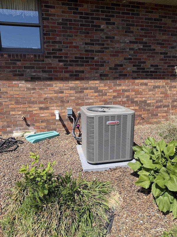 Completed full HVAC system installation including a 2.5-ton, 15.5 SEER Bryant air conditioning unit positioned on concrete pad with proper refrigerant line routing, and a 96% efficiency gas furnace installed in interior utility closet with new ductwork connections and PVC venting. All equipment tested and operational, system financed through third-party provider.