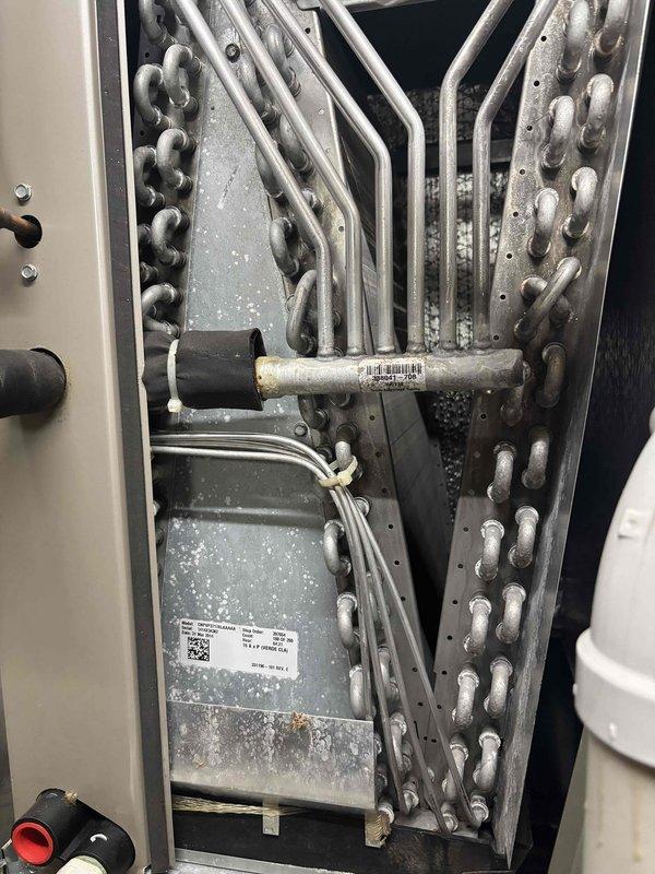 Completed Gold Level planned maintenance on an 11-year-old single-system HVAC unit during first visit. Performed comprehensive system diagnostics including electrical measurements with digital multimeter, recording voltage readings of 14.18V, and conducted thorough inspection of evaporator coil assembly and refrigerant lines. All components found operating within normal parameters, with minor dust accumulation noted on heat exchanger surfaces and metal panels.