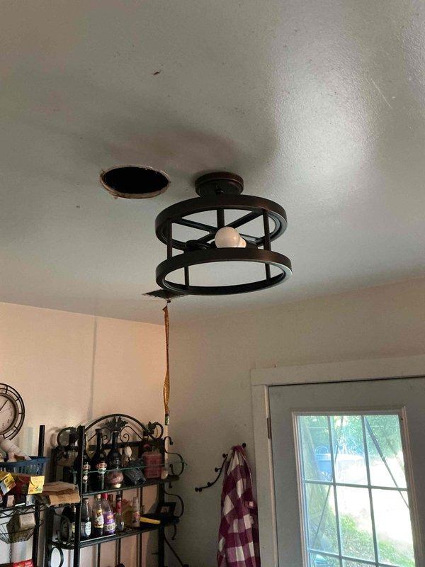 Responded to follow-up service call to complete lighting installation work previously scheduled. Upon arrival, confirmed that customer-supplied light fixtures were damaged and could not be installed. Documented existing ceiling-mounted decorative cage fixture currently in place and photographed uninstalled motor housing component still in packaging. Unable to complete installation due to defective customer-provided materials.