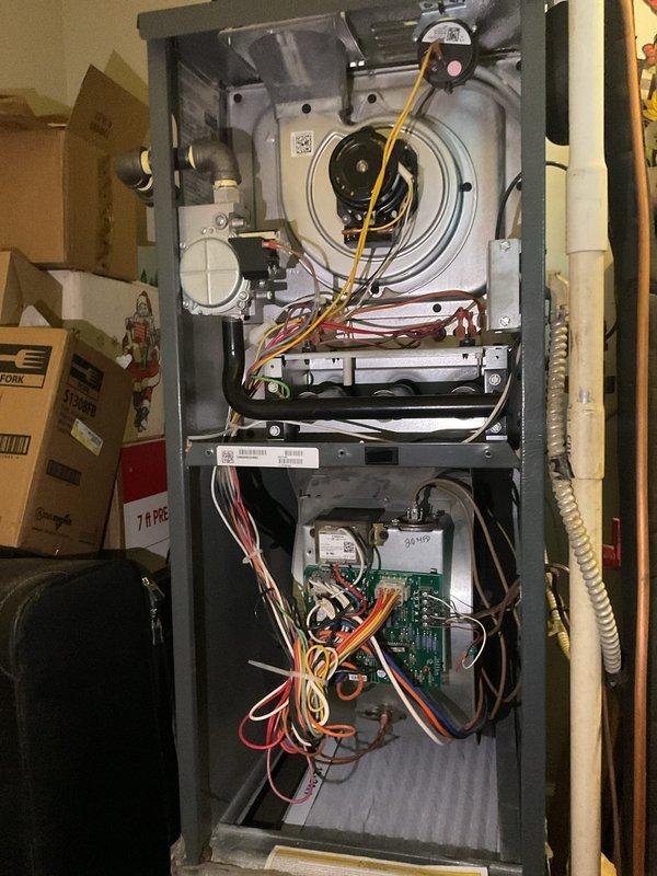 Completed planned maintenance visit on residential HVAC system with 12x24x1 filter specification in its fifth year of service. Performed comprehensive inspection of outdoor condensing unit and indoor air handler, accessing internal components to verify proper operation of capacitor, wiring connections, and blower motor assembly. Documented system condition with photography showing condenser coils, electrical connections, control board, and heat exchanger sections for maintenance records.