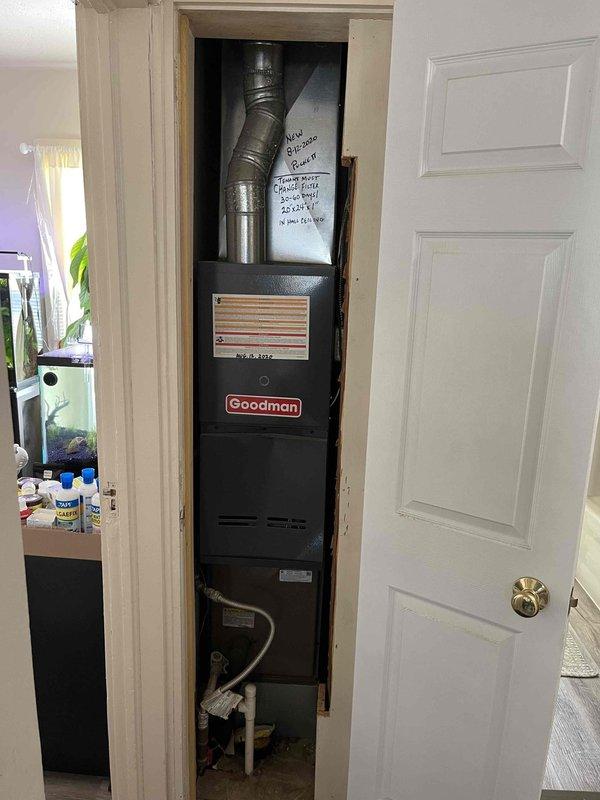 Responded to no-cool complaint on Goodman HVAC system with indoor temperature reading 77°F against 73°F setpoint. Inspected vertical furnace installation in utility closet and outdoor condenser unit positioned in side yard. System was running but failing to achieve adequate cooling capacity. Evaluated ductwork connections and found concerns regarding potential air loss through crawl space as reported. Documented equipment condition showing 10+ year old unit with standard wear patterns typical for age of system.