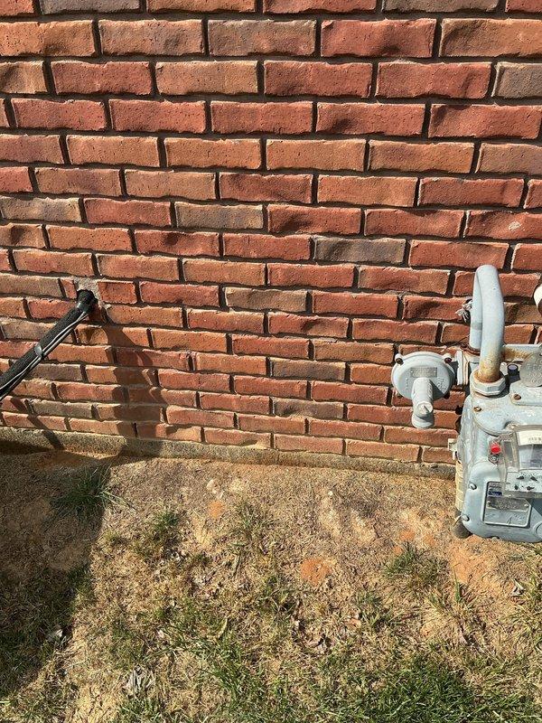 Conducted comprehensive site assessment for tankless water heater installation. Documented existing utility infrastructure in basement area, including current plumbing configuration, electrical routing through ceiling joists, and available mounting locations along concrete block foundation wall. Evaluated exterior gas meter location and connection points at building exterior to determine optimal routing for new gas line supply. Captured detailed measurements and photographic documentation of workspace constraints, existing utility cart positioning, overhead clearances, and wall-mounted infrastructure to develop accurate material takeoff and installation plan for tankless unit replacement.
