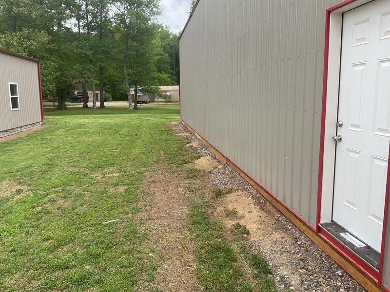 Completed HVAC estimate for new system installation in detached garage pole barn structure with no existing equipment. Assessed metal building with exposed wooden framing, cement board walls, and concrete slab flooring currently under construction. Evaluated space requirements, load calculations, and equipment placement options for climate control system to serve the workshop area.