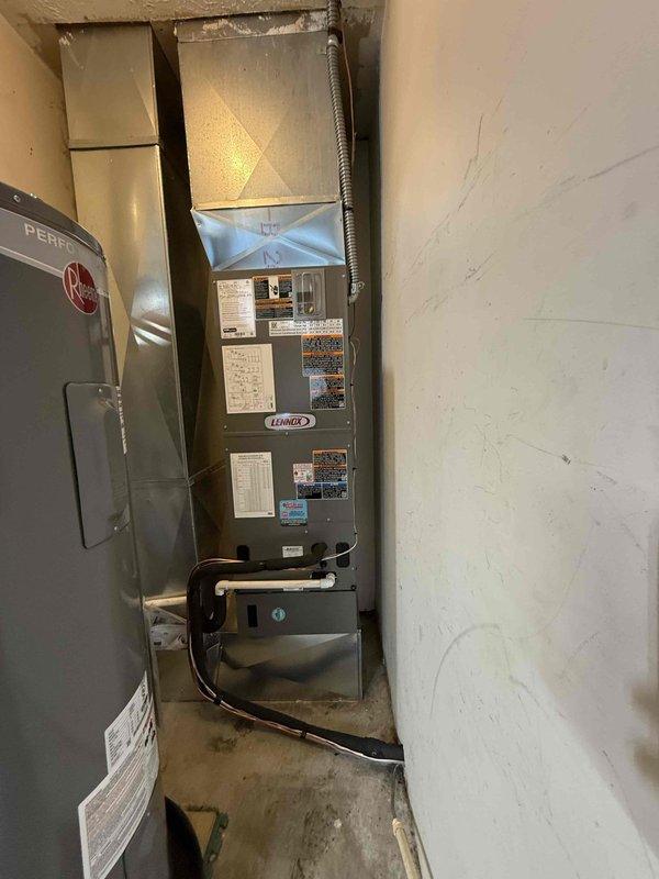 Completed installation of a 2.5-ton, 14 SEER heat pump system including outdoor condensing unit and indoor air handler with proper refrigerant line connections and electrical hookup. All equipment serial numbers documented per requirements, system tested and verified operational.