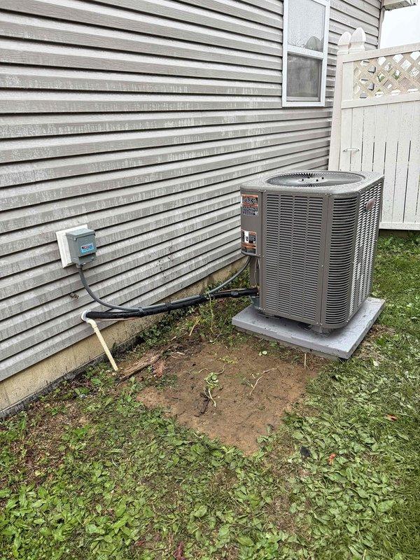 Completed installation of a 2.5-ton, 14 SEER heat pump system including outdoor condensing unit and indoor air handler with proper refrigerant line connections and electrical hookup. All equipment serial numbers documented per requirements, system tested and verified operational.