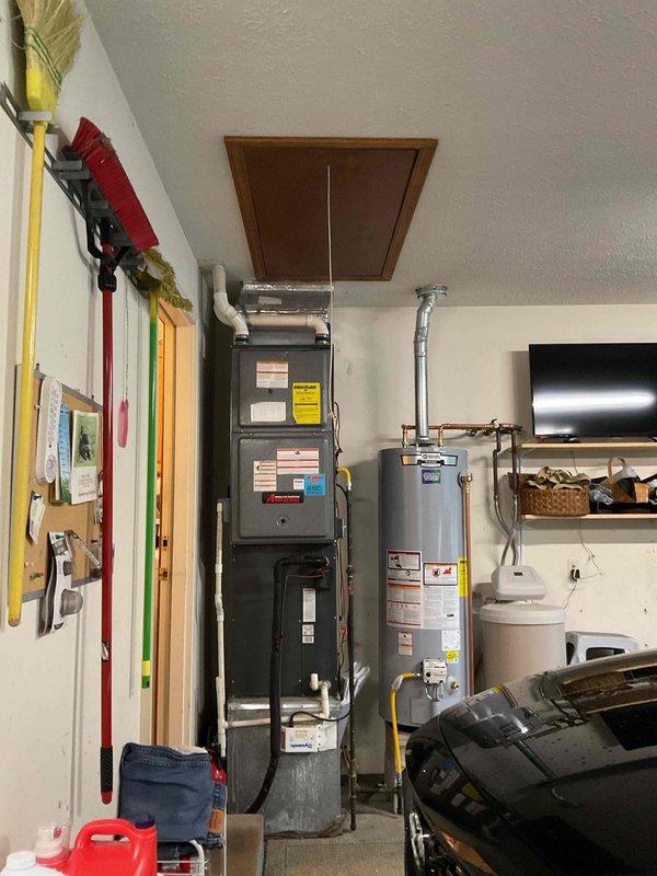 Conducted comprehensive HVAC system replacement estimate at residential property. Evaluated existing outdoor air conditioning condenser unit positioned on concrete pad against exterior brick wall, including assessment of copper refrigerant lines, electrical disconnect, and conduit connections to meter box. Inspected indoor furnace unit and water heater located in utility room, documenting equipment specifications, ductwork configuration, and existing infrastructure to provide complete system replacement recommendations for improved energy efficiency and performance.