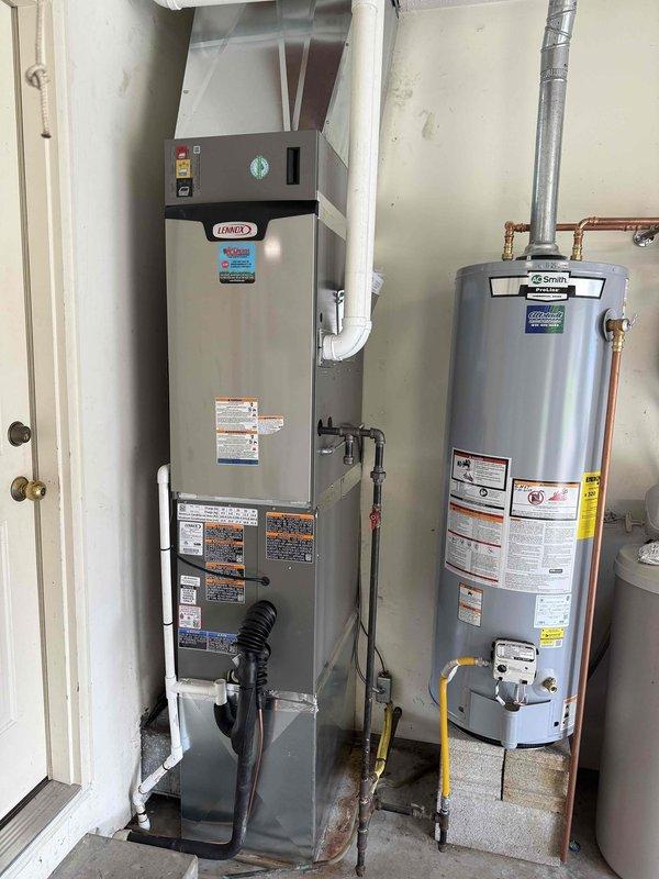 # HVAC System Installation

Completed full residential HVAC system installation including a 3-ton, 17 SEER Lennox air conditioning condenser unit and 97% efficiency Lennox furnace with matching air handler. Outdoor condenser positioned on concrete pad against brick exterior wall with proper clearances maintained. Installed electrical disconnect, metering equipment, and conduit per code requirements. Indoor furnace unit installed in utility closet with PVC venting system properly configured for high-efficiency condensing operation. Connected all refrigerant lines, gas supply lines with appropriate shut-off valves, and drainage systems. Verified proper electrical connections, tested all safety controls, and confirmed system operation at manufacturer specifications. Installation includes integration with existing A.O. Smith water heater in mechanical room. All equipment properly labeled, secured, and commissioned for optimal performance.