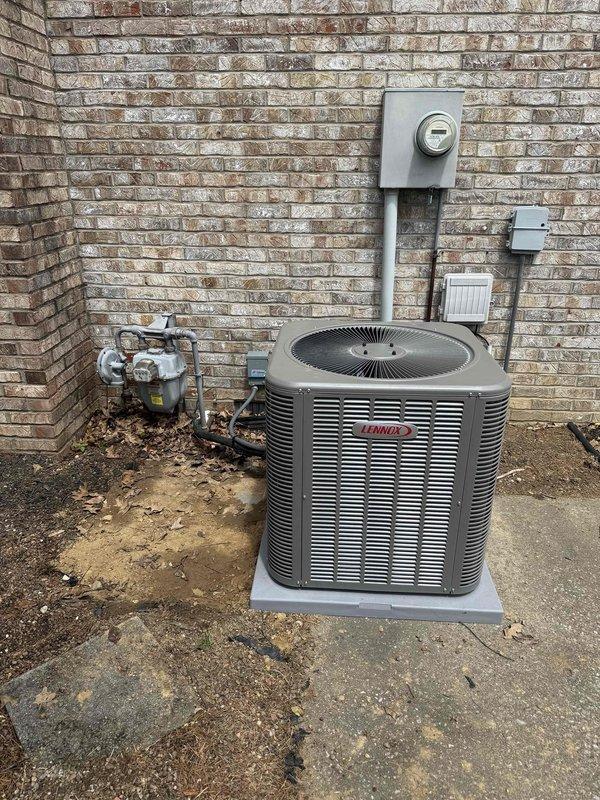 # HVAC System Installation

Completed full residential HVAC system installation including a 3-ton, 17 SEER Lennox air conditioning condenser unit and 97% efficiency Lennox furnace with matching air handler. Outdoor condenser positioned on concrete pad against brick exterior wall with proper clearances maintained. Installed electrical disconnect, metering equipment, and conduit per code requirements. Indoor furnace unit installed in utility closet with PVC venting system properly configured for high-efficiency condensing operation. Connected all refrigerant lines, gas supply lines with appropriate shut-off valves, and drainage systems. Verified proper electrical connections, tested all safety controls, and confirmed system operation at manufacturer specifications. Installation includes integration with existing A.O. Smith water heater in mechanical room. All equipment properly labeled, secured, and commissioned for optimal performance.