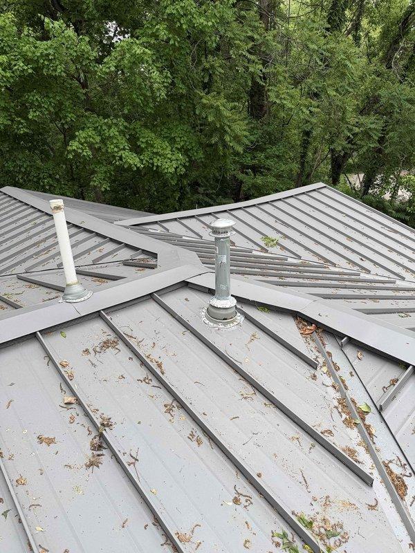 Installed new metal flue pipe for Lochinvar water heater, routing through utility room ceiling and terminating through standing seam metal roof. Ensured proper venting clearances, sealed roof penetration, and verified draft operation upon completion.