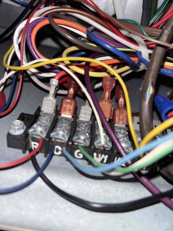 Responded to callback for HVAC system not operating following previous repair from 4/27. Upon inspection, discovered extensive frost and ice buildup throughout evaporator compartment and drain pan area, indicating restricted airflow or refrigerant issue causing coil to freeze. Inspected low-voltage control wiring at thermostat terminal connections, verifying proper wire terminations at C, G, and W1 terminals. System completely non-operational at time of arrival, requiring further diagnosis to determine root cause of recurring failure and excessive frost accumulation.