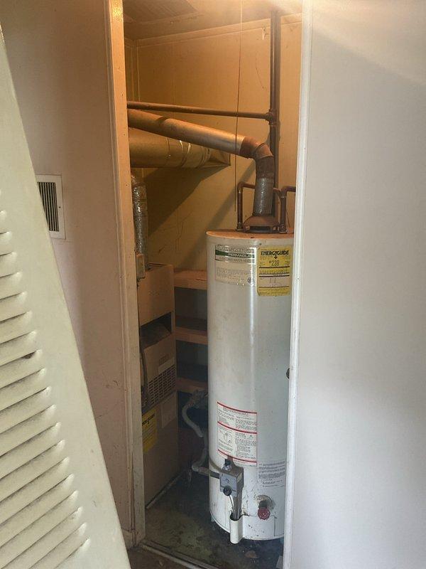 Completed comprehensive HVAC replacement estimate for 1950s-era residential property with no existing central air conditioning system and minimal ductwork infrastructure. Assessed utility closet containing current conventional tank water heater and evaluated crawl space conditions with exposed soil floor, aged wooden joists, and metal support columns to determine feasibility for new HVAC equipment installation and complete duct system design. Provided replacement estimate options for full central heating and cooling system, extensive ductwork installation throughout structure, and tankless water heater conversion to replace existing conventional unit.