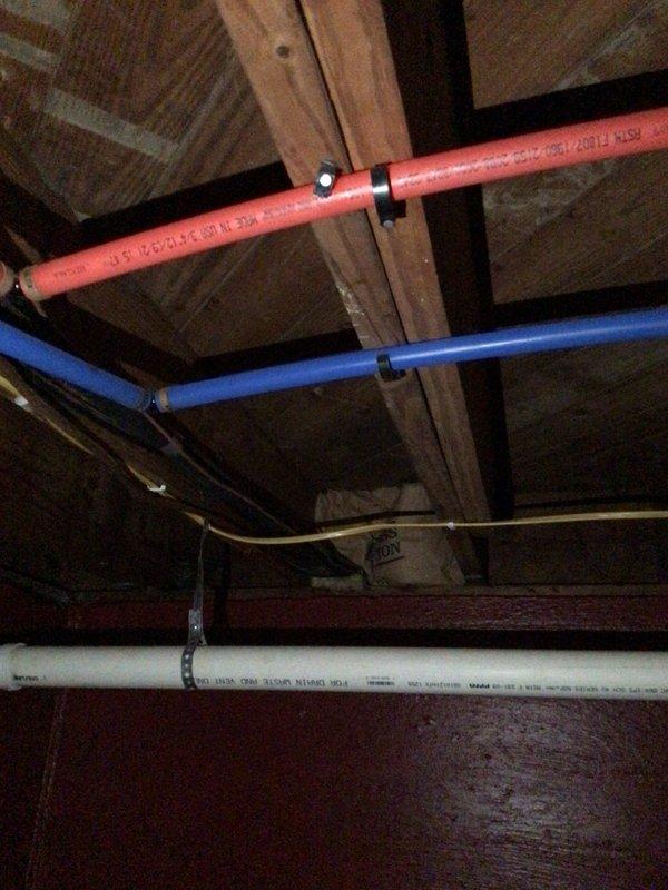 Responded to no cooling complaint where indoor blower fan operated but system failed to produce cold air. Upon inspection of air handler unit located in attic space, performed diagnostic evaluation of HVAC system. Verified airflow through supply vents and confirmed absence of evaporator coil freeze-up. Assessed electrical connections, refrigerant lines, and condensate drainage system for proper operation. Documented existing installation showing air handler with associated ductwork and plumbing infrastructure in serviceable condition.