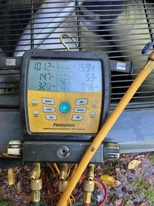 Responded to warranty service call for 5-year-old air conditioning system blowing warm air with no cooling. Performed leak search as scheduled from previous visit and conducted diagnostic testing using refrigerant manifold gauges to measure system pressures and temperatures. Found abnormal pressure readings indicating TXV malfunction affecting refrigerant flow and system performance. Documented equipment conditions with photos of diagnostic readings and thermostat displaying 86°F indoor temperature against 61°F setpoint, confirming inadequate cooling. Identified thermostatic expansion valve as failed component requiring replacement under warranty coverage. Part ordered for follow-up installation to restore proper system operation.