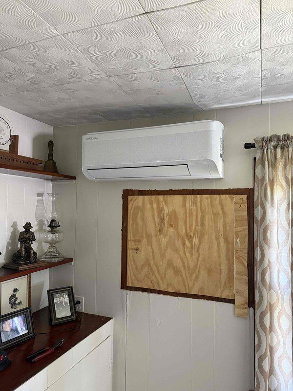 Completed installation of 3-ton multi-zone ductless mini-split system with three indoor head units. Installed indoor air handler unit in residential living space with proper wall mounting, refrigerant line connections, and condensate drainage routing through vertical PVC pipe system. System tested and verified operational upon completion.