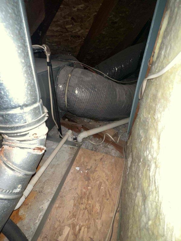 Completed HVAC replacement estimate for 22-year-old residential system located in attic space. Inspected existing Carrier brand air handler unit with associated refrigerant lines, ductwork, and attic installation configuration. Documented current equipment condition, including horizontal air handler positioning, copper refrigerant piping with multiple connections, metallic supply ductwork, and insulated flex duct runs throughout confined attic space. Assessed attic access, structural support adequacy, existing duct layout, and available clearances for replacement equipment installation. Photographed equipment labels, refrigerant line routing, duct connections, and overall mechanical system layout to prepare comprehensive replacement proposal. Provided information regarding promotional timing and confirmed homeowner availability requirements for future installation coordination.