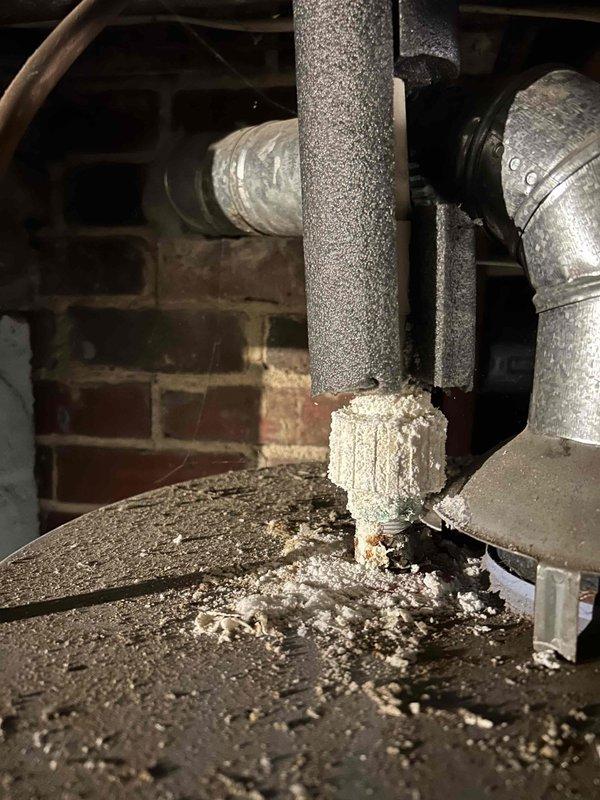 Completed annual Platinum Level maintenance on a 5-year-old HVAC system, including replacement of 20x25x5 filter and comprehensive inspection of all components. Identified deteriorated PVC coupling at base of condensate drain line with visible cracking and material breakdown requiring attention. Documented plumbing infrastructure including shut-off valves, insulated piping, and drain pan positioning for system monitoring.