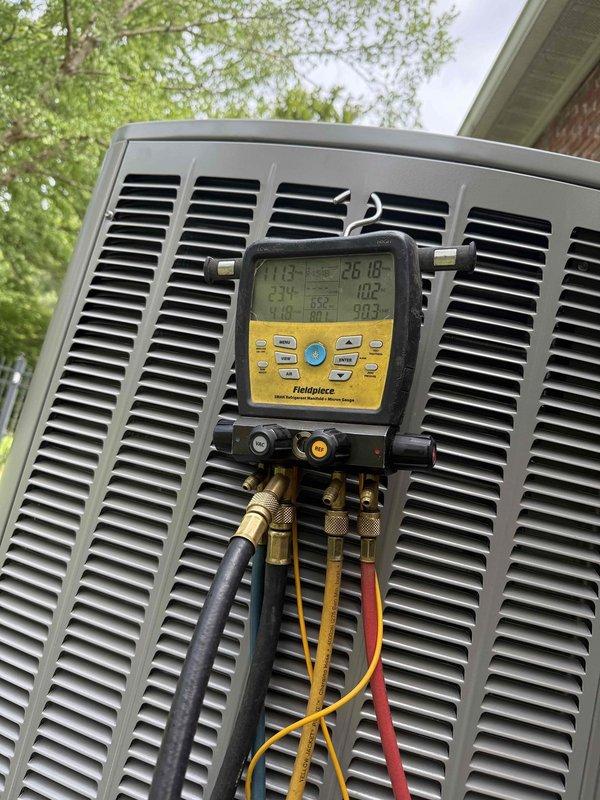 Completed installation of a 2-ton Lennox HVAC system including an 18 SEER air conditioning condenser unit and 97% AFUE upflow furnace. The outdoor condenser unit was positioned on a concrete pad against the building exterior with proper clearances maintained for optimal airflow and serviceability. All refrigerant lines were installed and the system was charged to manufacturer specifications, with pressure and temperature readings verified using digital diagnostic equipment to ensure proper operation. Electrical disconnect was mounted for safe system shutdown capability during future maintenance.