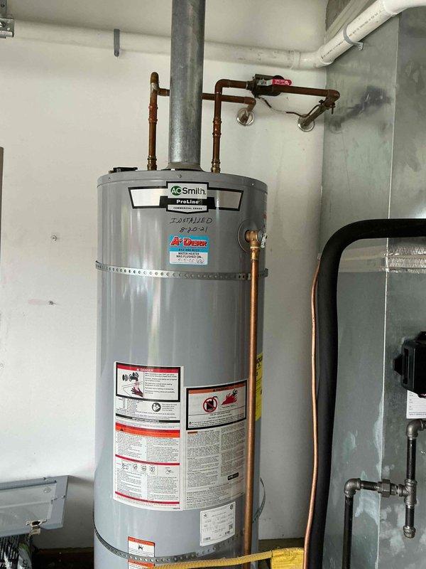 # Plumbing Maintenance - Tanked Water Heater Flush

Performed comprehensive maintenance flush on A.O. Smith ProLine tanked water heater unit. Connected drain hose to tank drain valve and successfully evacuated sediment and mineral buildup from tank bottom to exterior concrete pad. Inspected copper supply piping, gas line connections, and flue vent for proper operation. All components verified in good working condition following flush procedure. Unit restored to optimal operating efficiency.