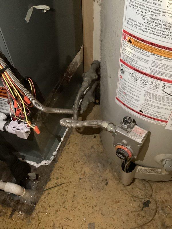 Responded to inquiry regarding water heater replacement options for residential property. Conducted on-site evaluation of existing gas-fired tank-style water heater located in mechanical room alongside HVAC equipment. Assessed current installation including gas supply lines, venting configuration, electrical connections, and available clearances for potential equipment upgrades. Documented existing conditions showing standard residential water heater with gas control valve, flexible gas connector, and proper safety labeling. Evaluated HVAC ductwork routing and utility connections to determine feasibility of both traditional tank-style and tankless water heater installations. Discussed advantages and specifications of both system types with homeowner, including energy efficiency considerations, space requirements, and installation parameters. Provided comprehensive estimate for replacement options based on site conditions and customer preferences.