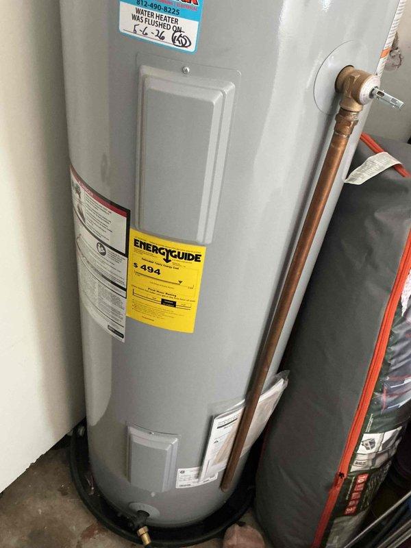 Completed routine tanked water heater maintenance flush on a 2-year-old AO Smith Signature 100 residential unit as part of the USA Bronze maintenance plan. Performed standard drain and flush procedure to remove sediment buildup from the tank bottom, inspected all connection points including braided supply lines and copper piping for proper operation, and affixed service completion sticker documenting the maintenance date. Unit operating within normal parameters with no leaks or deficiencies noted upon completion.