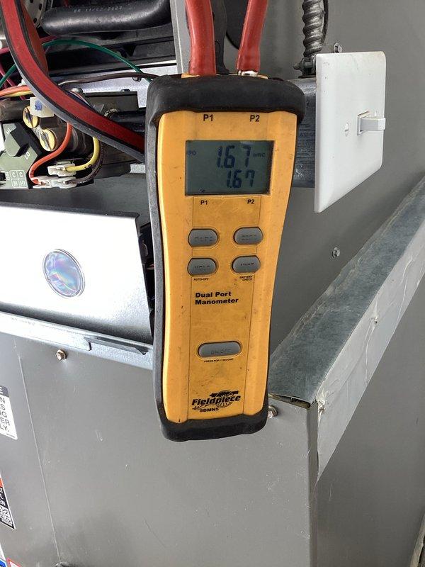 # HVAC Maintenance - Planned Single Maintenance

Completed annual preventive maintenance inspection on residential HVAC system. Performed system diagnostics using digital manometer, recording pressure readings of 16.1 on both P1 and P2 ports to verify proper refrigerant charge and system performance. Inspected attic-mounted air handler unit, ductwork with reflective foil insulation, copper refrigerant lines, and condensate drain system including PVC piping and drain pan. Measured supply air temperature at 80.5°F using digital thermometer to confirm proper airflow and temperature differential. Verified all electrical connections, wire terminations, and safety controls were secure and functioning correctly. System operating within normal parameters with no deficiencies noted.