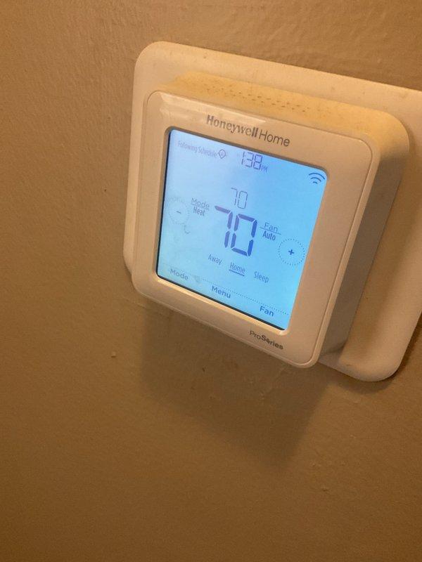 Completed scheduled AC tune-up and preventative maintenance on residential HVAC system. Verified thermostat operation and proper temperature control settings, confirmed system responding correctly in heating mode with auto fan operation. Inspected air handler unit and electrical connections, documented system condition with photos for service records.