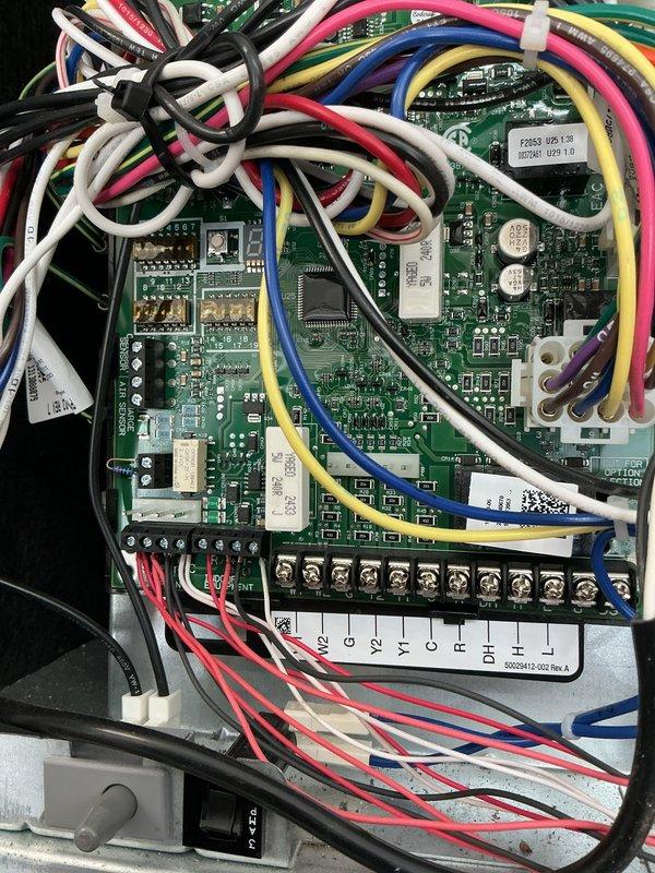 Completed annual planned maintenance on HVAC system including inspection of control board assembly, wiring connections, and terminal strip functionality. Verified all wire connections secure at terminal points (C, Y1, O, R, DH), reviewed charging temperatures and pressures documentation for model SL25KCV, and confirmed proper system operation per manufacturer specifications. Replaced 20x25x5 Pure Air filter as part of routine maintenance schedule.