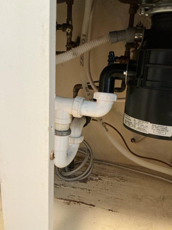 Responded to emergency service call for water leaks following new refrigerator installation. Upon arrival, main water supply was shut off due to active leaks at kitchen sink faucet and refrigerator ice maker supply line. Inspected under-sink plumbing connections and identified dripping from both the kitchen faucet water supply and the refrigerator ice maker line connection point. Tightened compression fittings on the ice maker supply line and kitchen faucet supply connections. Verified proper seating of ferrules and checked all braided stainless steel flex lines for damage or wear. Restored main water supply and pressurized system. Conducted thorough leak check of all connections including P-trap assembly, garbage disposal connections, and supply valves. Confirmed all fixtures operating properly with no active leaks. Educated customer on proper valve operation for future appliance installations. Water service fully restored to residence.