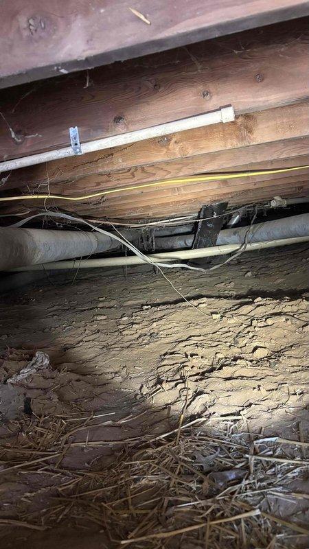 Conducted comprehensive HVAC system evaluation for complete replacement estimate, including assessment of existing ductwork conditions in crawl space and return air system. Inspected underfloor infrastructure revealing aged ductwork, electrical components, and structural considerations for new system installation. Evaluated interior return air grille and ventilation pathways to determine requirements for complete system replacement and duct cleaning services, providing customer with options for full HVAC system upgrade and ductwork remediation.