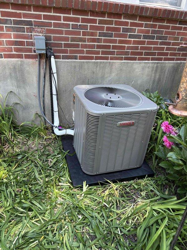 Installed a complete 2.5-ton Lennox air conditioning system including indoor evaporator coil integrated with existing furnace and outdoor condensing unit. The outdoor unit was positioned on a rubber isolation pad against the building's brick exterior with proper electrical disconnect and refrigerant line connections via PVC-concealed penetrations. All work was completed under permit RES-HVAC-26-03197 with proper refrigerant charging, system testing, and verification of airflow through existing ductwork infrastructure.