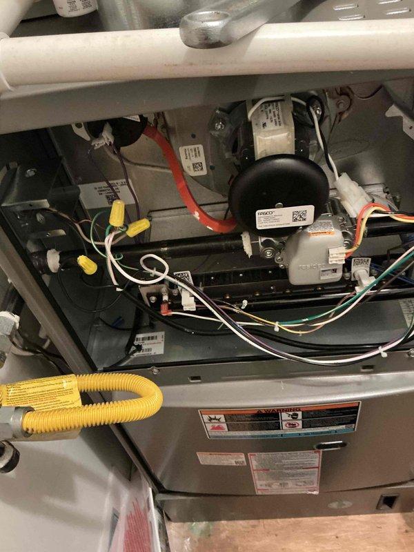 Responded to emergency gas leak call for dual-system residential HVAC installation. Upon arrival, confirmed strong constant gas odor inside structure near furnace location. Gas utility company had previously shut off meter valve due to leak detection. Performed comprehensive leak detection inspection of gas supply lines, connections, and furnace manifold using electronic leak detector and soap bubble solution. Identified leak at yellow flexible gas connector (CSST) connection point at furnace inlet. Inspected black iron pipe gas supply line, red shutoff valve, and all threaded fittings for additional leak sources. Verified proper torque and thread sealant application on all gas line connections. Tightened loose flex connector fitting and re-tested connection points. Conducted complete system pressure test to verify leak repair integrity. Inspected furnace internal components including blower motor, electrical connections, and burner assembly for proper operation and safety compliance. 