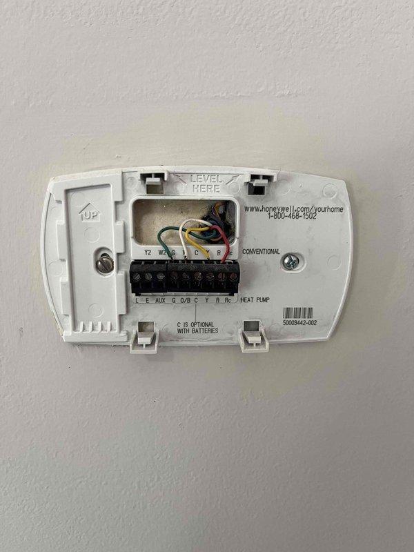 Conducted comprehensive HVAC system evaluation for full replacement estimate at owner-occupied single-family residence. Assessed existing 20-year-old air conditioning system experiencing recurring failures and heating equipment of undetermined age. Documented current system configuration including Honeywell conventional thermostat with standard wiring (R, C, Y, W, G terminals), interior blower assembly, refrigerant line connections, and condensate drainage system. Photographed thermostat wiring schematic and internal mechanical components to determine proper equipment sizing and compatibility requirements for complete system replacement. Provided consultation on whole-house heating and cooling replacement options based on existing infrastructure and equipment condition.