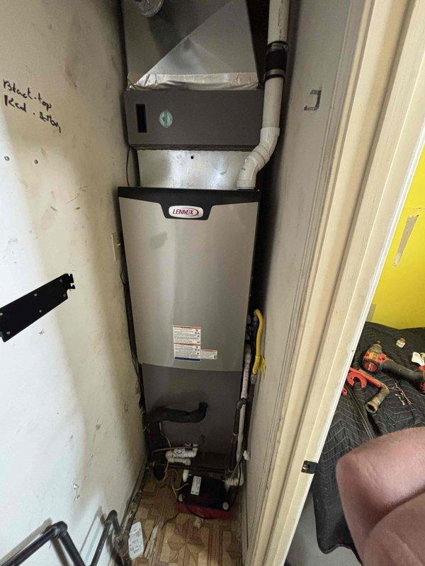 Completed furnace replacement with new Lennox unit installed in utility closet. Verified system operation with temperature readings at 83.4°F and confirmed proper airflow through ductwork connections. Installation tested and operational upon completion.