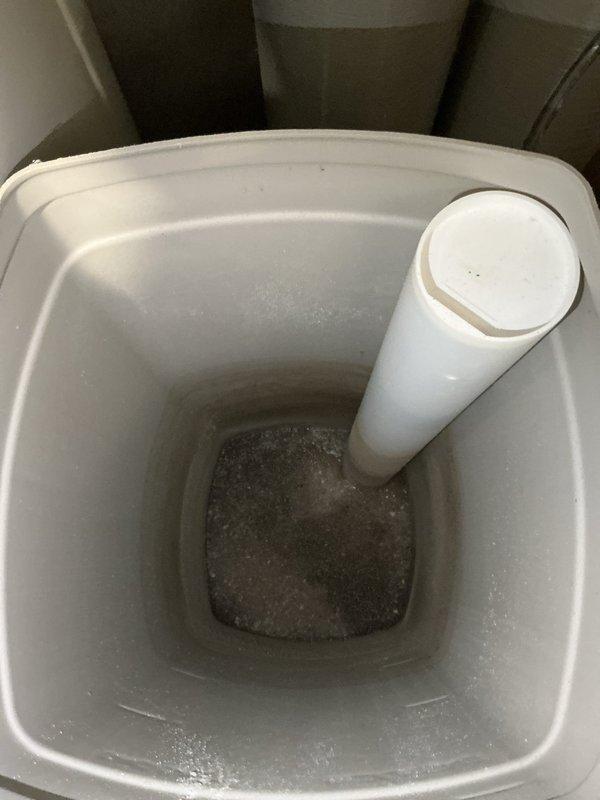 Responded to service call for RainSoft water softener system emitting strong odor. Upon arrival, inspected dual-tank water treatment system and brine tank. Removed contaminated salt from brine tank, which showed significant sediment and debris buildup at bottom causing malodorous conditions. Cleaned and sanitized brine tank interior, removing accumulated residue and organic matter. Refilled system with fresh water softener salt and verified proper operation of digital control head. Tested system cycling and confirmed elimination of odor issue. System restored to normal operating condition.