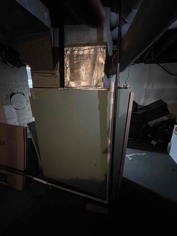 Conducted comprehensive replacement estimate for non-functional HVAC system that had lost all refrigerant charge due to leak and utilizes obsolete refrigerant no longer available for service. Evaluated existing outdoor condensing unit showing visible corrosion and weathering on cabinet panels, assessed indoor ductwork and air handler components in basement mechanical space, and documented current system configuration. Provided complete replacement options to restore cooling capacity to residence.