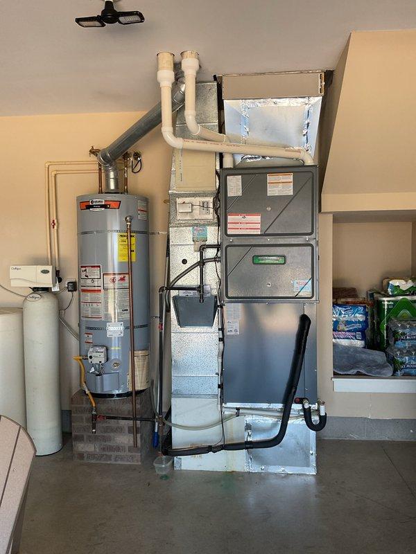 Completed Platinum Level annual maintenance on a 6-year-old single HVAC system with Aspen refrigerant evaporator unit (Model CG800-14-2-45R057) utilizing R-410A refrigerant with TXV installed. Performed comprehensive inspection of equipment located in garage installation alongside water heater. Verified proper operation of evaporator coil assembly, checked refrigerant lines and PVC condensate drainage system, and inspected all visible components including ductwork connections. System operating within normal parameters with design pressure rated at 500 PSI. Filter size confirmed as 24x25x5 for future reference. Equipment labels and safety warnings documented via photographs for service records. All maintenance procedures completed per manufacturer specifications and Platinum Level service protocol.