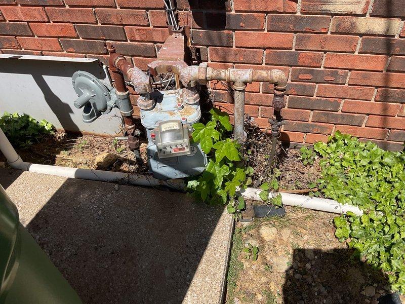 Conducted comprehensive on-site evaluation for whole-house generator installation at residential property equipped with natural gas service and breaker panel. Assessed existing electrical infrastructure including main service meter, exterior conduit routing, and utility connections mounted on brick exterior wall. Documented current electrical service configuration, meter location, gas line accessibility, and optimal placement considerations for standby generator system. Evaluated weathered utility components and determined requirements for transfer switch installation, load calculations, and integration with existing electrical distribution system.