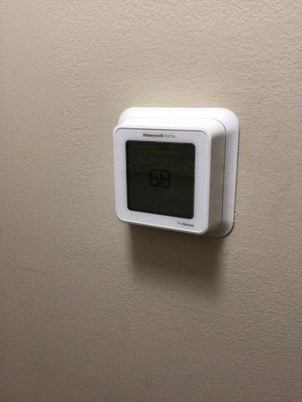 Completed annual Platinum Level maintenance on a 4-year-old HVAC system with a 20x20x2 filter. Performed comprehensive inspection of air handler unit and associated components in mechanical room, verified thermostat operation showing 69°F on Honeywell Home ProSeries digital control, and noted that one support leg under outdoor condensing unit requires replacement.