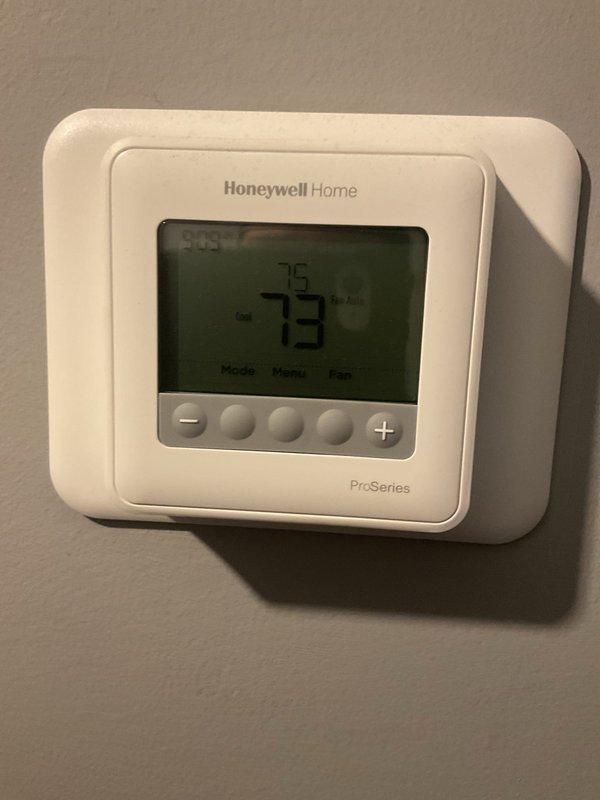 Completed annual planned maintenance visit on HVAC system. Verified thermostat operation showing 73°F on Honeywell Home ProSeries digital unit. Performed electrical diagnostics using clamp meter to measure current draw on outdoor condensing unit, confirming proper amperage levels. System operating within normal parameters with 16x20x5 filters noted at 2 years service life.