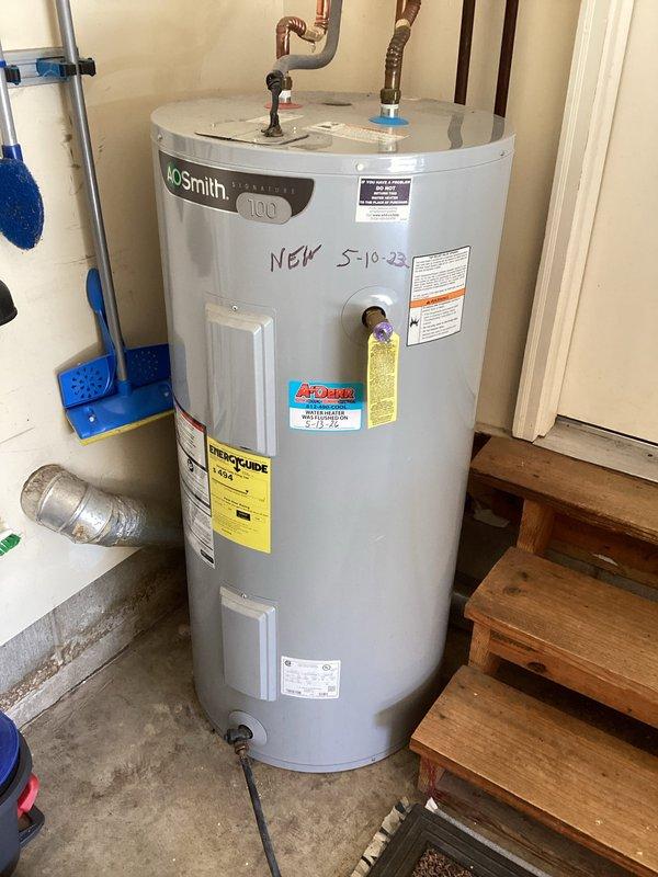 # Plumbing Maintenance - Tanked Water Heater Flush - A+

Performed routine maintenance flush on an AO Smith tanked water heater to remove sediment buildup and ensure optimal performance. The unit, installed in 2023, showed normal operating conditions with all safety labels and specifications clearly visible. Connected copper supply lines, shut-off valve, and pressure relief valve were inspected and found to be in proper working order.

Executed complete tank flush procedure by connecting drain hose to the drain valve at the base of the unit and thoroughly evacuating accumulated sediment from the tank bottom. Allowed water to run clear to ensure complete removal of mineral deposits and debris that can reduce heating efficiency and tank longevity. Verified proper drainage and checked for any signs of corrosion or leaks around the tank body and connection points.

Inspected all plumbing connections at the top of the unit, including hot water outlet and cold water inlet lines with associat