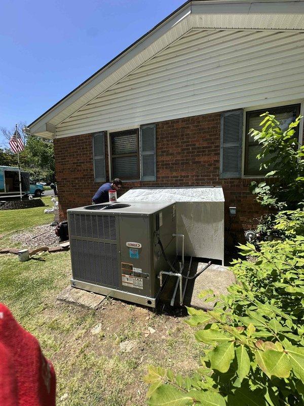 Completed full HVAC system installation consisting of a 2-ton, 14 SEER gas pack unit at residential property. Positioned new equipment on concrete pad adjacent to brick exterior wall, ensuring proper clearances and level placement. Verified all electrical connections, refrigerant lines, and gas supply connections meet manufacturer specifications and local code requirements. System tested and operational upon completion.