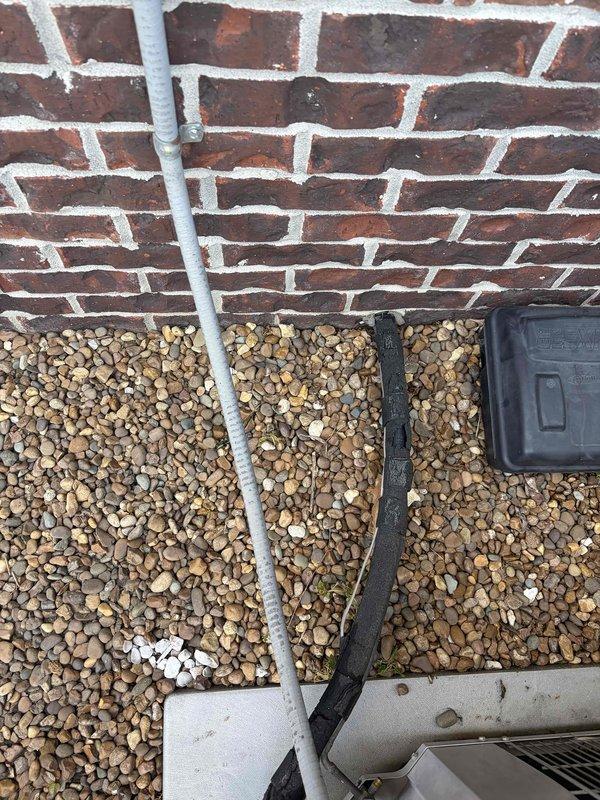 Conducted comprehensive site assessment for complete HVAC system replacement at residential property. Evaluated existing outdoor condensing unit positioned on gravel pad adjacent to brick exterior wall, noting current condensate drainage configuration and electrical service connection. Inspected interior ductwork installation including insulated supply plenums in upper-level space, documenting existing duct routing and mounting hardware for replacement system sizing and compatibility requirements.