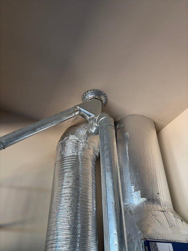 Conducted comprehensive site assessment for complete HVAC system replacement at residential property. Evaluated existing outdoor condensing unit positioned on gravel pad adjacent to brick exterior wall, noting current condensate drainage configuration and electrical service connection. Inspected interior ductwork installation including insulated supply plenums in upper-level space, documenting existing duct routing and mounting hardware for replacement system sizing and compatibility requirements.